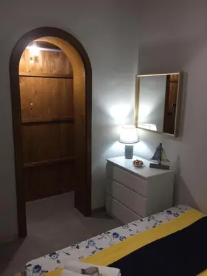 a bedroom with a bed and a dresser and a mirror at Terra e Mare in Capaci