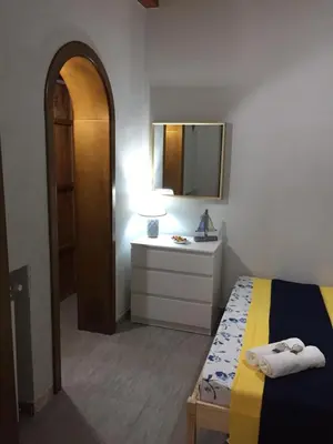 a bedroom with a bed and a sink and a mirror at Terra e Mare in Capaci