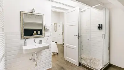 a white bathroom with a sink and a shower at Addimora Boutique Suites in Palermo