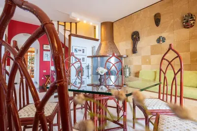 a kitchen and dining room with a glass table and chairs at Villa nel verde sul mare, Mondello, Palermo in Palermo