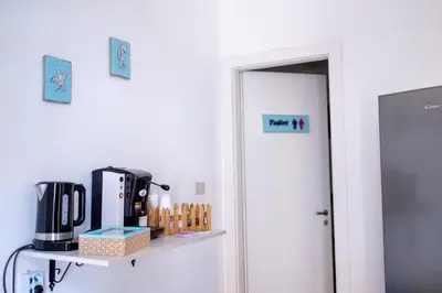 a door to a room with a coffee maker on a shelf at Zangara Flat in Cinisi