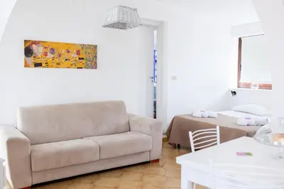 a living room with a couch and a table at Zangara Flat in Cinisi