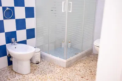 a bathroom with a shower with a toilet and a sink at Zangara Flat in Cinisi