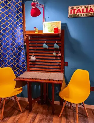 a table and two yellow chairs in a room at CasuzzaMia in Palermo