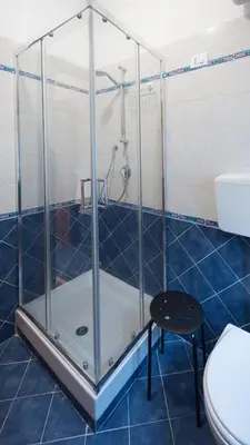 a shower in a bathroom with a toilet and a stool at Casa Annuccia ai Quattro Canti di Città in Palermo