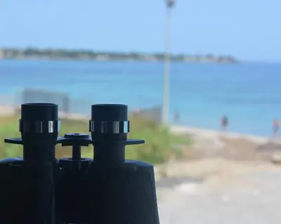 a pair of binoculars sitting on top of a tripod at Sea Front in Carini