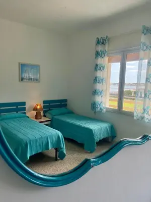 a bedroom with two beds and a mirror at Sea Front in Carini