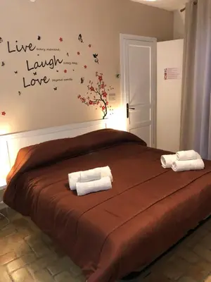 a bedroom with a large bed with two towels on it at La casa del Cedro in Palermo