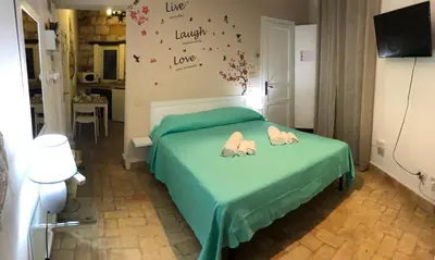a bedroom with a bed with two people laying on it at La casa del Cedro in Palermo