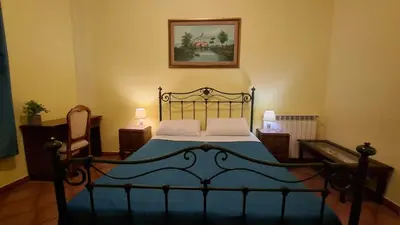 a bedroom with a bed with blue sheets and pillows at VENTO di MARE in Palermo