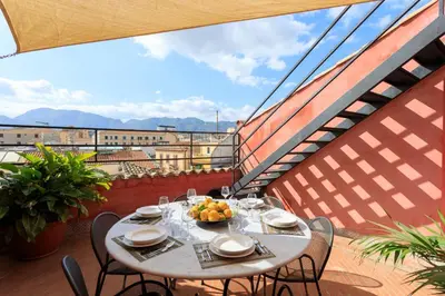 a table with a bowl of fruit on a balcony at Palermo Magic House in Palermo