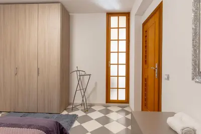 a bedroom with a bed and a checkered floor at Residenza del Duca - Casteldaccia 2 camere in Casteldaccia