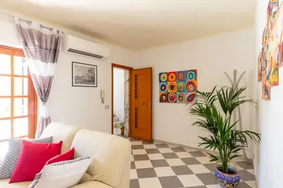 a living room with a white couch and a checkered floor at Residenza del Duca - Casteldaccia 2 camere in Casteldaccia