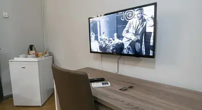 a flat screen tv hanging on a wall at GiaChi friendly rooms alla Stazione in Palermo