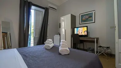 a hotel room with a bed with towels on it at GiaChi friendly rooms alla Stazione in Palermo