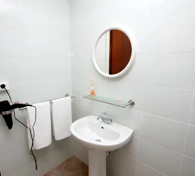a white bathroom with a sink and a mirror at GiaChi friendly rooms alla Stazione in Palermo