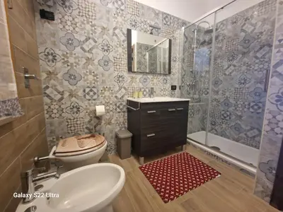 a bathroom with a toilet and a sink and a shower at Casa Sabrina in San Vito lo Capo