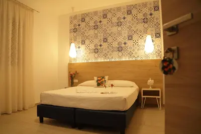 a bedroom with a bed with a floral wall above it at Terra d'amare in Castelluzzo