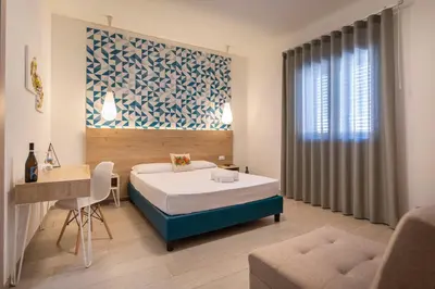 a bedroom with a bed and a table and a couch at Terra d'amare in Castelluzzo