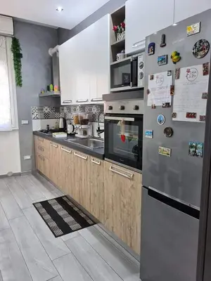 a kitchen with a stainless steel refrigerator with magnets at Casa Le Rose in Palermo