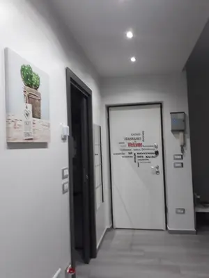 a hallway with a door with a plant on the wall at Casa Le Rose in Palermo