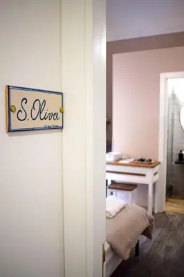 a room with a bed and a sign on a wall at B&B Benincasa in Palermo