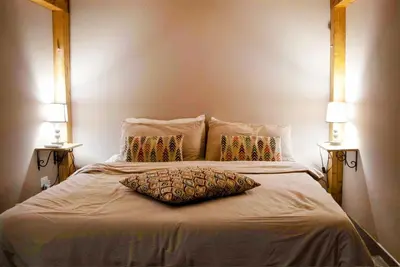 a bed with a pillow on it with two lamps at B&B Benincasa in Palermo