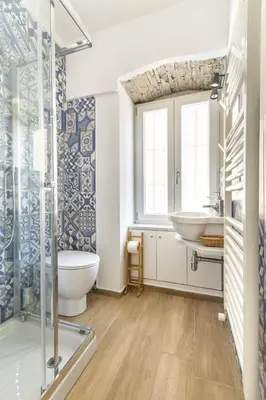 a bathroom with a tub and a sink and a mirror at Teatro Massimo City Center Apartments in Palermo