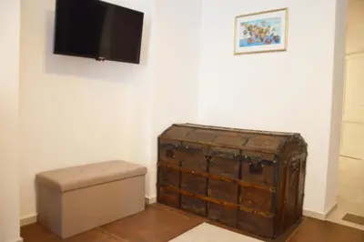 a room with a toilet and a television on a wall at Teatro Massimo City Center Apartments in Palermo