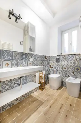 a bathroom with two sinks and a tub and a toilet at Teatro Massimo City Center Apartments in Palermo