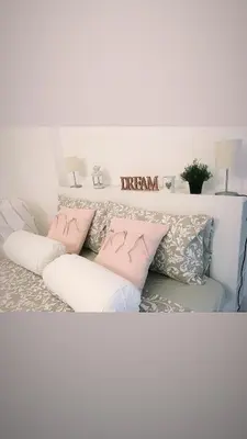 a living room with a couch with pillows at Lisetta's house in Monreale
