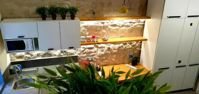 a kitchen with white cabinets and a sink and a table at Mediterraneo House in Palermo