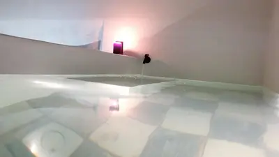 a white room with a mirror and a white tile floor at Mediterraneo House in Palermo