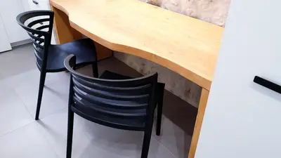 a wooden table with two black chairs under it at Mediterraneo House in Palermo