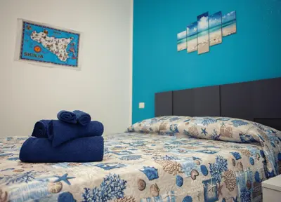 a bedroom with a bed with a towel on it at La Trinacria in Terrasini