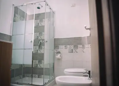 a bathroom with a shower and a toilet and a sink at La Trinacria in Terrasini