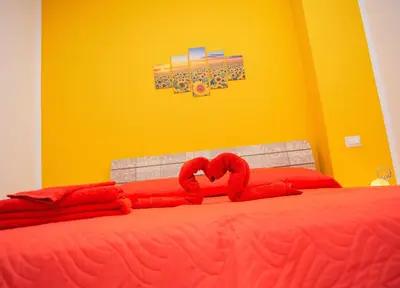 a bed with red pillows on top of it at La Trinacria in Terrasini