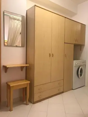 a kitchen with a large cabinet and a washing machine at Casa Vacanze Ciullo d'Alcamo in San Vito lo Capo