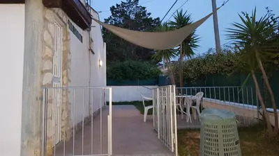a patio with a hammock attached to a house at villa Roby in Trappeto