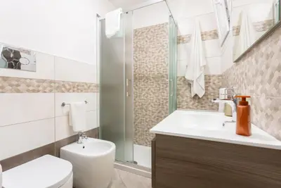a bathroom with a toilet and a sink and a shower at villa Roby in Trappeto