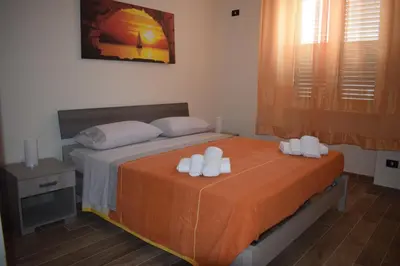 a bedroom with a bed with white towels on it at Affitto breve Casa Taormina in Palermo