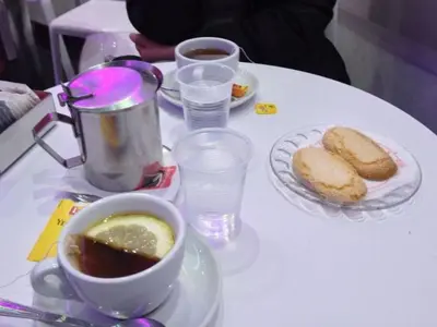 a table with a cup of coffee and a plate of bread at Gibellina Home in Nuova Gibellina