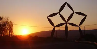 a sunset with the sun setting behind a windmill at Gibellina Home in Nuova Gibellina