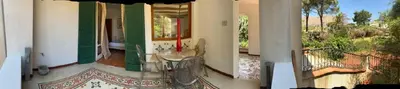 a swimming pool with two chairs and a table next to it at Park House in Mondello