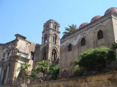 an old building with a tower and a church at B&B Villa Liberty sul Mare by Wonderful Italy in Palermo