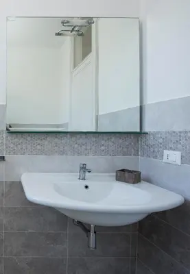 a white sink in a bathroom with a mirror at B&B Villa Liberty sul Mare by Wonderful Italy in Palermo