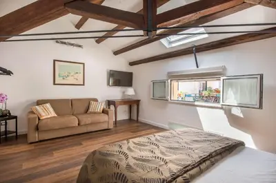 a living room with a bed and a couch at B&B Villa Liberty sul Mare by Wonderful Italy in Palermo