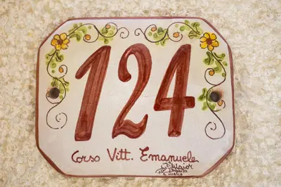a plaque with a number with flowers and vines at La Dimora Di Segesta in Calatafimi