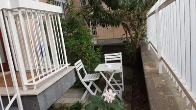 two white chairs and a table on a porch at Clambè in Palermo