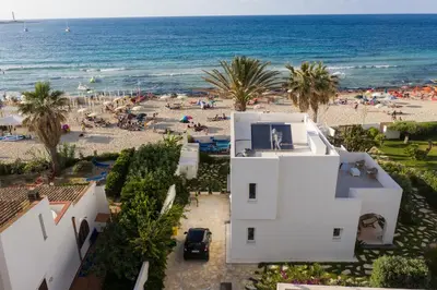 an aerial view of a beach and a white building at Villa Acquamarina sul mare in San Vito lo Capo